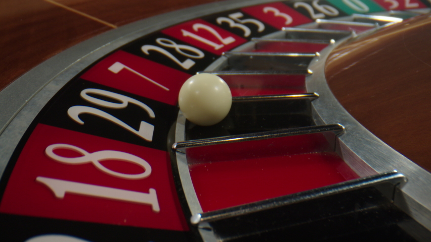 Casino roulette in motion. White ball drops to number 29 while the wheel spinning. The Roulette Table in the Casino.
