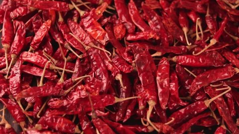 Dry chilli peppers,spicy seasoning,lot of dried chili as a food background,Dried red peppers on a wooden table,red dry Chili pepper background,Dry paprika hd footage
