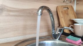 clear water pours from the tap in the kitchen with a strong pressure video