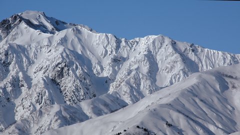 Snow mountains of wonderful scenery with blue sky is winter view in Hakuba, Nagano, Japan.