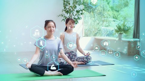 Young asian women doing yoga. Health care technology. Mindfulness.