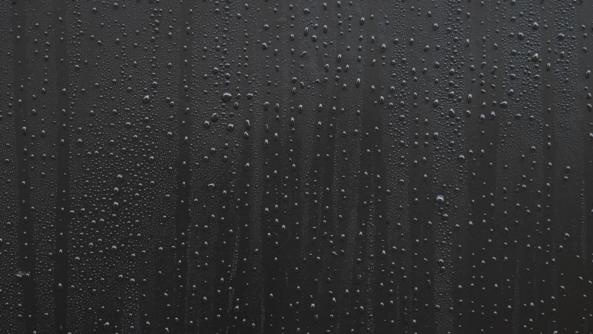 Water droplets flowing on a black background. | Shutterstock HD Video #1067374328