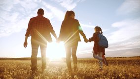 happy family walking in the park. friendly family kid dream concept. mom dad and child kid walk in the park on green lifestyle grass outdoors. happy family with their backs walking in the park - Powered by Shutterstock - Get 15% off with code: PIKWIZARD15