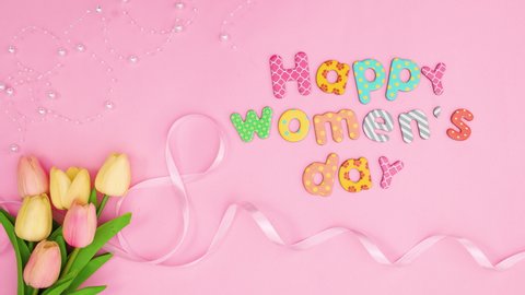 6k Happy women's day text move on pink theme with flowers and ribbons. Stop motion