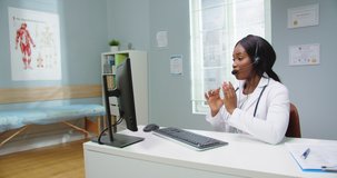 African female doctor wear headset make online video call consult patient. Afro american black woman therapist videoconferencing talking to camera in remote chat. Telemedicine, telehealth.