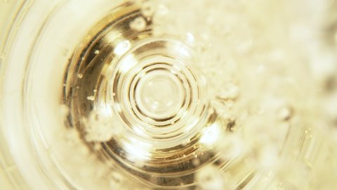 Super slow motion of pouring champagne into glass with camera motion. Filmed on high speed cinema camera, 1000 fps