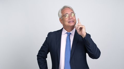 Middle age businessman standing and thinking an idea pointing the finger up over isolated background