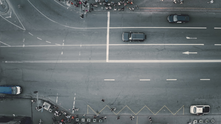 Top down cars stopped at road. Aerial people crosswalk zebra. Pedestrians cross traffic highway. Business center street. Cityscape transportation. Kyiv city, Ukraine, Europe. Cinematic drone shot Royalty-Free Stock Footage #1067403077