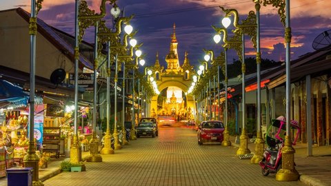 Nakhon Phanom, Thailand - 2 November 2019: Footage 4k Timelapse, Cars moving traffic on conjunction road, a beautiful road with street light decorating thai style in the evening.