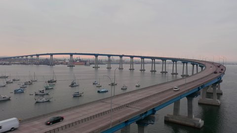 Drone Rises Next To Coronado Bridge Over San Diego Bay With Travelling Cars At Early Morning In California, USA. - aerial ascend