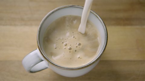 150fps SLOW MOTION WIDE frothy oat milk pours into a cappuccino