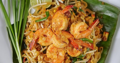 Close up rotation of Shrimp Pad Thai, Top view of Fried noodle Thai style with prawns. Thai food style.