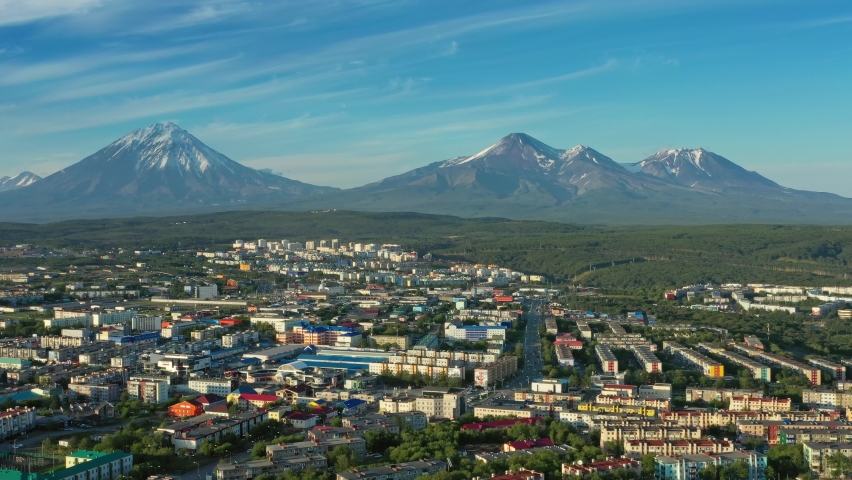 Flying over Petropavlovsk-Kamchatsky city at sunset and cone of volcano. Kamchatka Peninsula, Russia, 4k | Shutterstock HD Video #1067413874