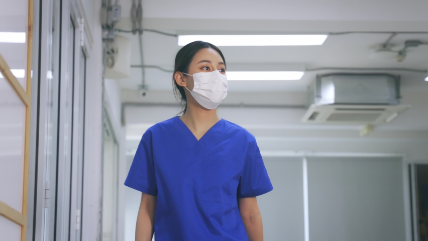 Young female healthcare workers wearing surgical mask shaking hands with elbow bump while maintaining social distancing during the outbreak of corona virus pandemic - 4k slow motion footage Royalty-Free Stock Footage #1067415374