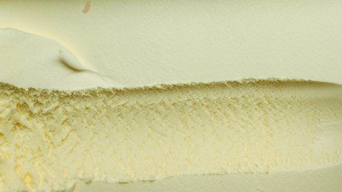 Ice cream Vanilla scooped out from container with a spoon yellow, Closeup Top view Food concept.
