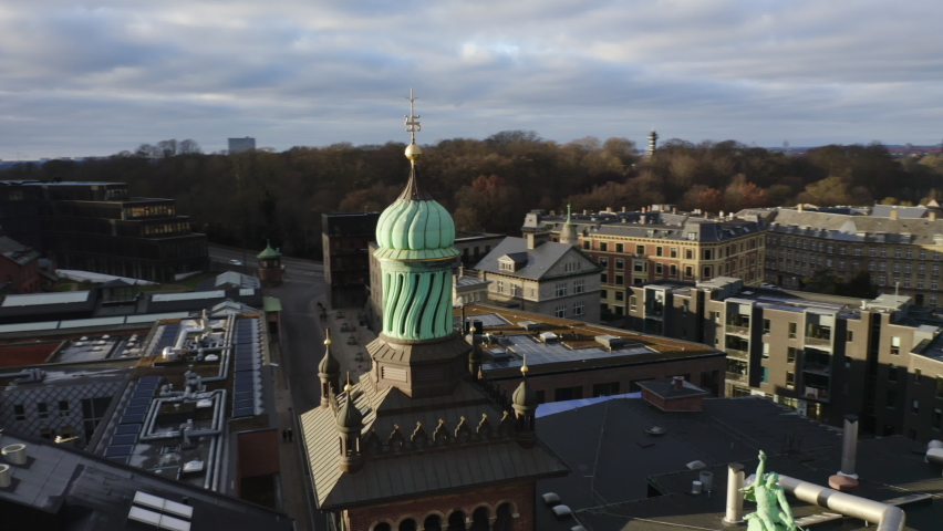 Wide Drone Flight Arcing Over The Elephant Tower And City Skyscrapers Of Carlsberg Byen, Copenhagen, Denmark