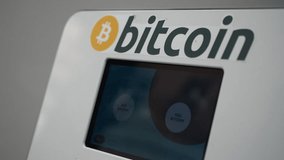 Woman selling bitcoin on cryptocurrency ATM machine in HD VIDEO. Blockchain technology in real people life concept. Close-up.