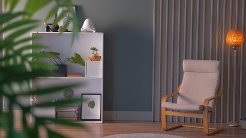 Decorative room, bookshelf, chair and orange lamp, interior style, home decoration.