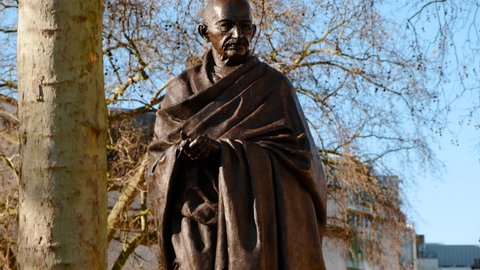 LONDON, circa 2021 - Close-up of the Statue of Mahatma Gandhi sculpted in bronze, located in Parliament Square, Westminster, London, England, UK