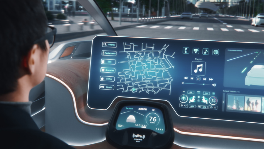 Futuristic Concept: Stylish Businessman Setting Location on an Interactive Navigation App on an Augmented Reality Dashboard while Sitting in an Autonomous Self-Driving Zero-Emissions Electric Car.  Royalty-Free Stock Footage #1067430881