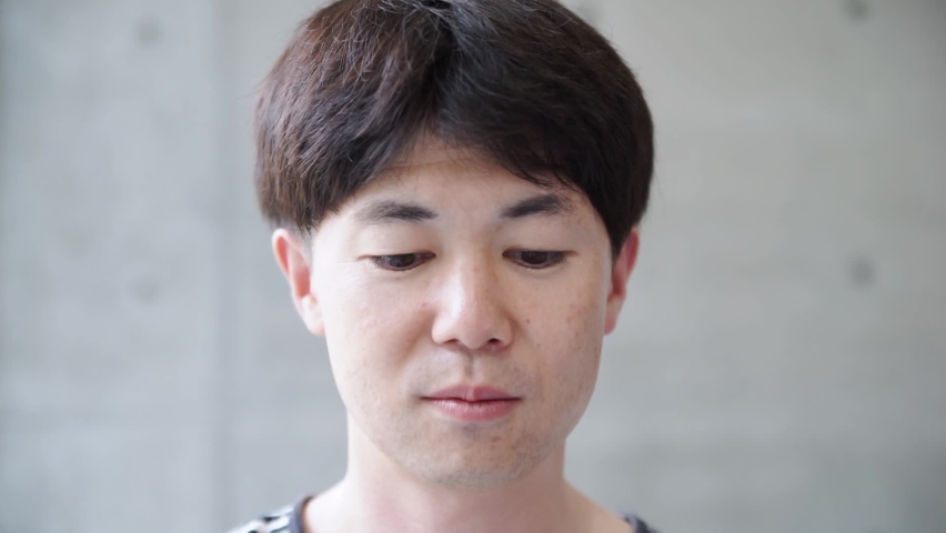 A man eating rice balls