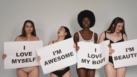 Four beautiful women holding signs with positive self affirmations