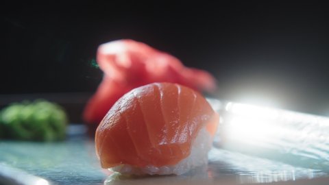Serve nigiri sushi with salmon on a spinning platter. Japanese traditional cuisine. Slow motion 4K video