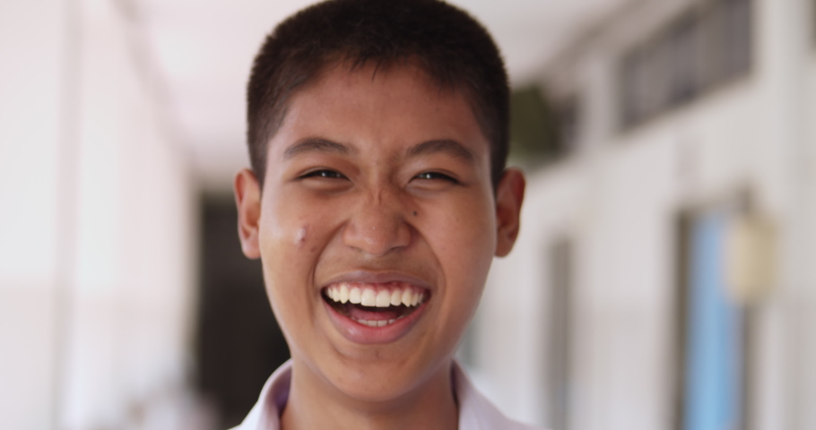 Slow motion shot of laughing male native Asian high school student in white uniform. | Shutterstock HD Video #1067450204