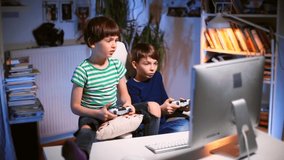 Gaming kids. Boys children play computer video games indoors. Manage application using controller.  Competitions in online games digital tools for child development. Innovative learning experiences 