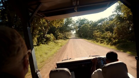 Tourist On Zanzibar African Safari Adventure On Holiday Vacation.Wild Nature Of Search Lions And Giraffe Serengeti Or Ngorongoro.Travel On Africa River Safari Adventure. Safari Trip On Tanzania Selous