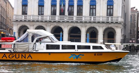 Venice, Italy - 18.11.2020: Water passenger bus passing by on grand canal tracking slow motion