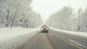 Cop car in high speed pursuit. Emergency response police patrol vehicle speeding to scene of crime. Heavy snowfall and fog on the road. Outdoor front view of police traffic auto driving.  - Powered by Shutterstock - Get 15% off with code: PIKWIZARD15