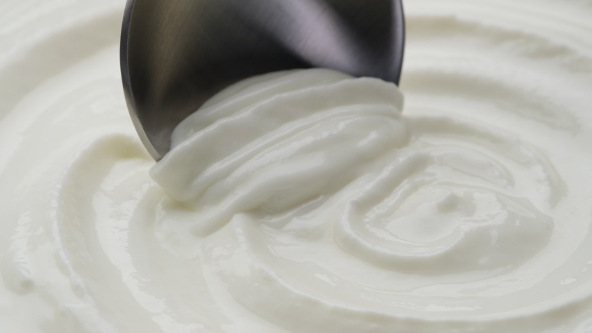 Sour cream with spoon, fresh greek yogurt close up | Shutterstock HD Video #1067458382