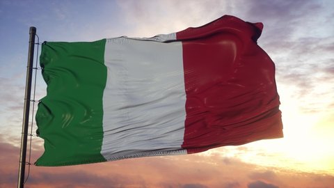 Flag of Italy waving in the wind against deep beautiful sky at sunset