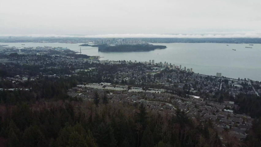 High view of Stanley park and Vancouver downtown on a cloudy autumn day