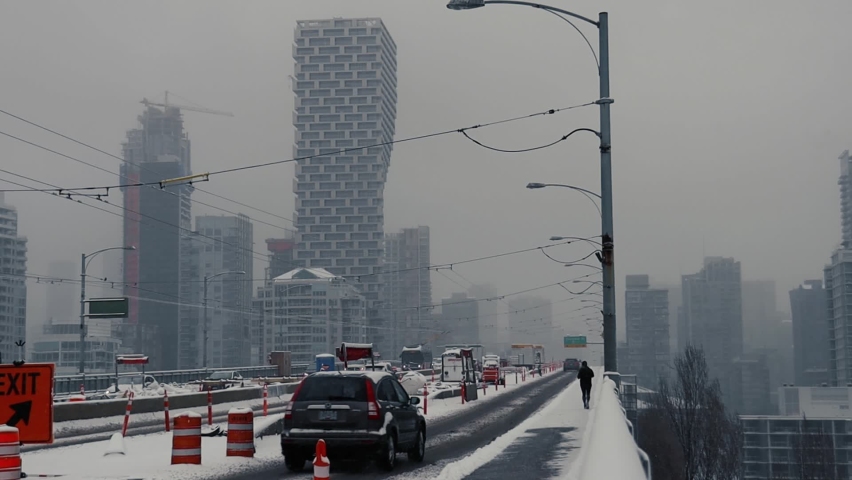 Construction on Granville bridge during snow with Vancouver downtown on back