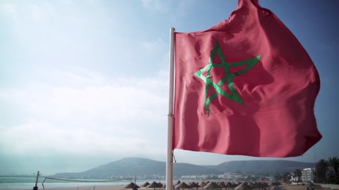 Morocco National Flag Waving In The Wind Against Blue Sky - medium shot