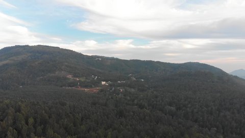 Aerial wide shot of a green forest on top of a hill in Yercaud on a summer day, conservation concept