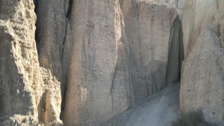A drone climbs upward to reveal some unique rock formations of the Afton Canyon, in the Mojave Desert of California.