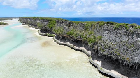 Aerial, Cliffs of Lekiny in the same lagoon as Mouli bridge. Exotic Ouvea Island. New Caledonia Tourism. High quality 4k footage. Territory of France.