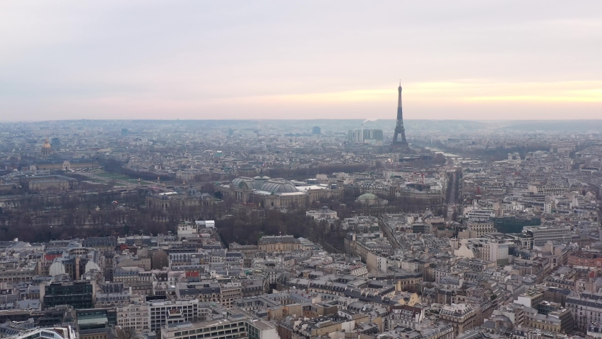 France, Paris, drone aerial view flying above buildings roofs. Grand Palais and Eiffel tower in the background Royalty-Free Stock Footage #1067494883