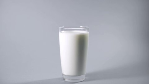 Cookie with chocolate chips are dipped into a glass of milk