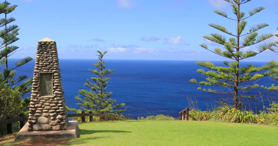 Right to left panning motion of the Captain Cook monument  at the spot on the northern coast of Norfolk Island where Captain James Cook and his officers landed in 1774, Norfolk Island, Australia