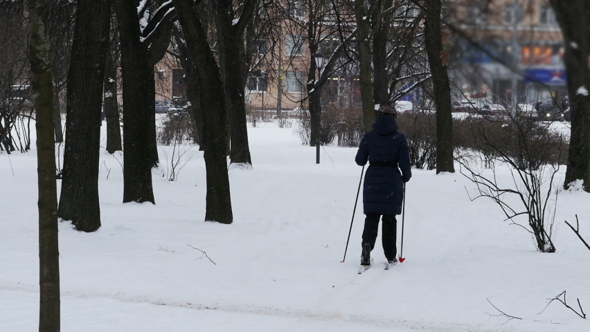 women skiing winter in the city park