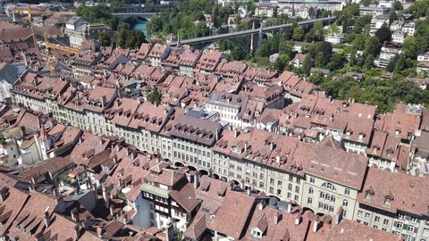 Bern old town, capital of Switzerland, and Aare River with bridges from panoramic terrace of Cathedral bell tower. Aerial view of cityscape of medieval city UNESCO World Heritage.