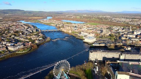 Aerial view over Limerick City in Republic of Ireland. There are number of eye-catching landmarks in Limerick such as Thomond Bridge, King John's Castle, St. Mary's Cathedral and River Shannon.