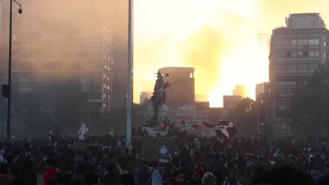 SANTIAGO, CHILE - FEBRUARY 10, 2021: SANTIAGO, CHILE - October 22, 2019 Protesters unfurl flags of the Mapu