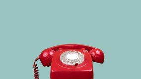 A stop motion shot of a red classic rotary telephone with the handset jumping up and down on its own - Powered by Shutterstock - Get 15% off with code: PIKWIZARD15