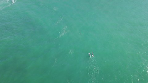 Kayakers Enjoying The Pristine Waters In Portreath Cornwall England- aerial wide shot