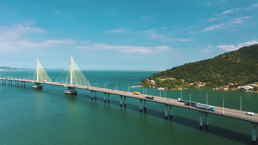 Amazing bridge above turquoise color ocean aerial view sunny day, located in Laguna, Santa Catarina, Brasil